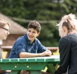 kids sitting table outside